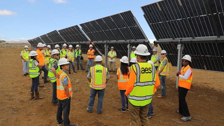 people infront of solar panel