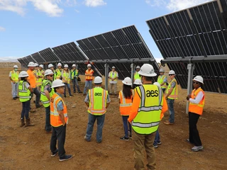 people infront of solar panel